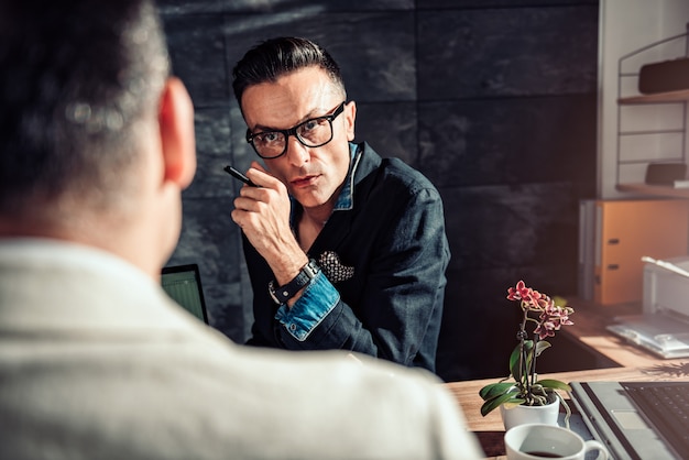 Businessman listening his colleague at the meeting