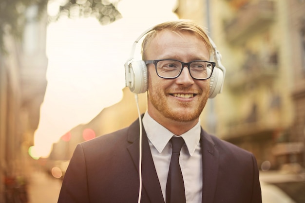 Businessman listening to music on the way