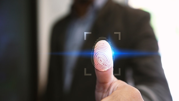 Photo businessman login with fingerprint scanning technology.