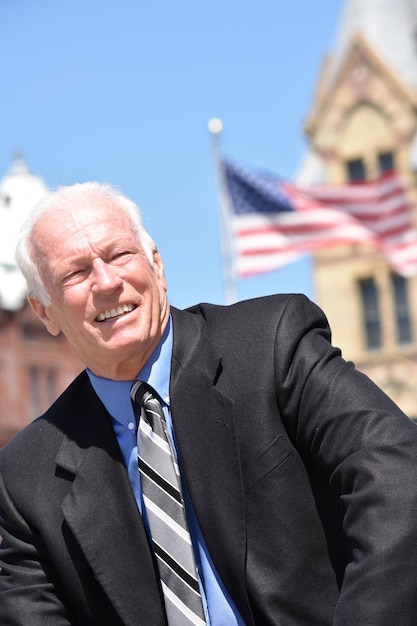 Businessman looking away against built structure and sky