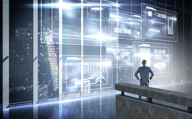 businessman looking away  against hologram interface in office overlooking city