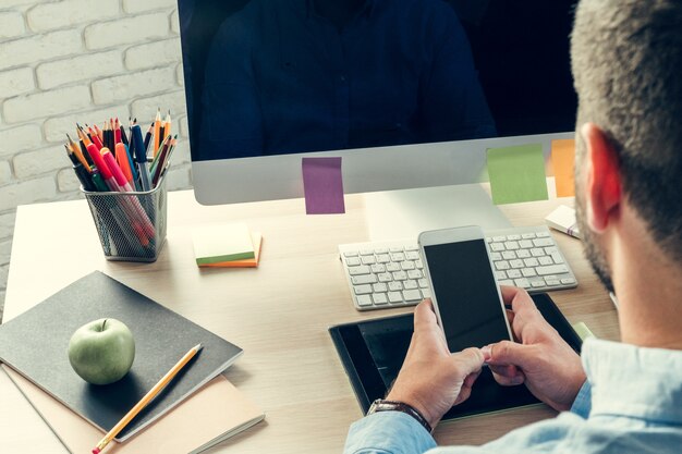 Foto uomo d'affari che esamina il monitor del computer durante il giorno lavorativo in ufficio