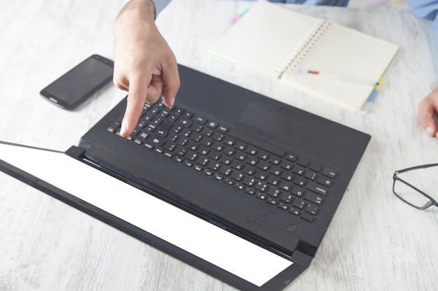 Businessman looking at computer monitor and showing with finger.