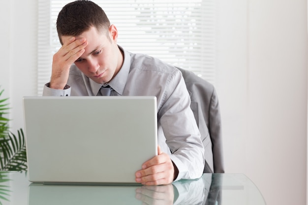 Businessman looking at his laptop