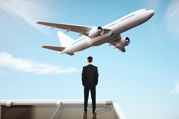 businessman looking at plane
