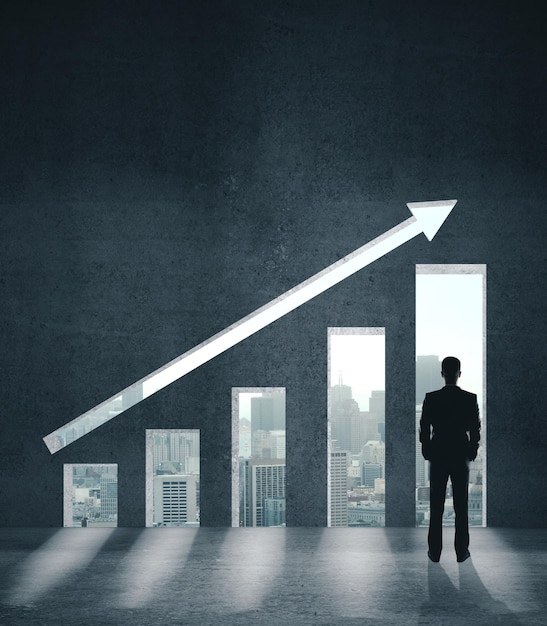 Businessman looking on stock chart on wall