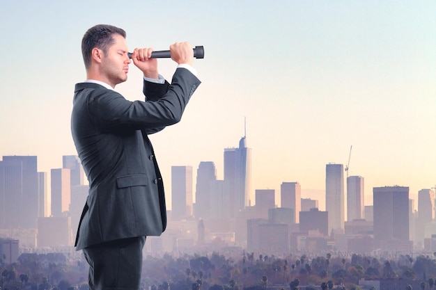 Businessman looking through a telescope