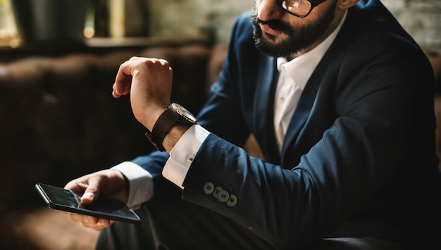 A businessman looking at a watch