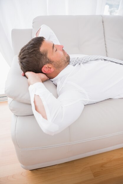 A businessman lying on the sofa