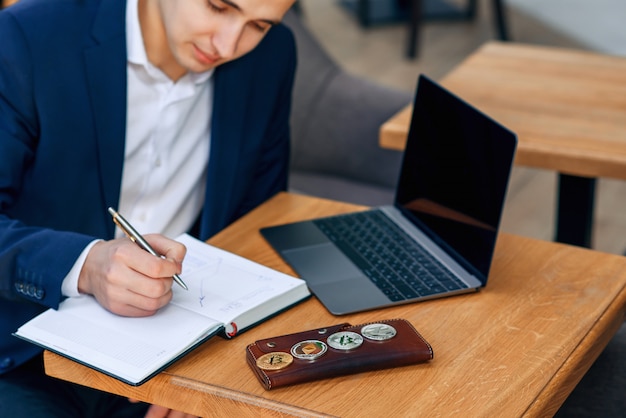 A businessman makes a note in his notebook