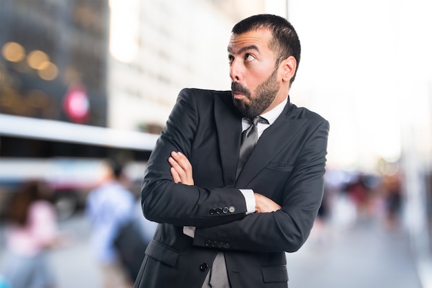 Businessman making unimportant gesture on unfocused background