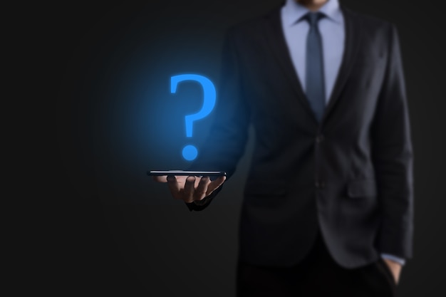 Businessman man hand hold interface question marks sign web. Ask quiestion online, FAQ concept, what where when how and why, search information on internet.