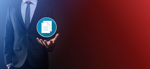 Businessman man holding a document icon in his hand Document Management Data System Business Internet Technology Concept. Corporate data management system DMS.flat icons with long shadows.