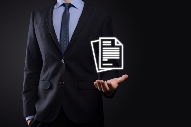 Businessman man holding a document icon in his hand Document Management Data System Business Internet Technology Concept. Corporate data management system DMS