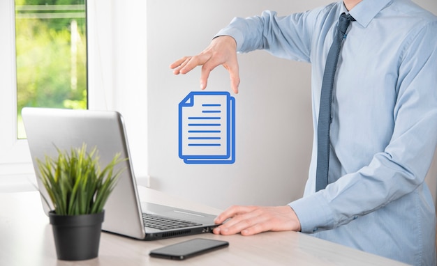 Photo businessman man holding a document icon in his hand document management data system business internet technology concept. corporate data management system dms .