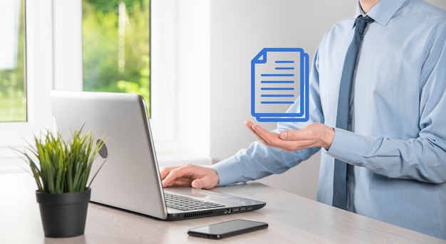 Businessman man holding a document icon in his hand Document Management Data System Business Internet Technology Concept. Corporate data management system DMS .