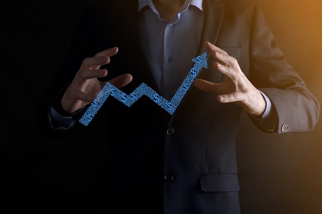 Businessman man holding a graph with positive profits growth. plan graph growth and increase of chart positive indicators in his business.more profitable and growing.