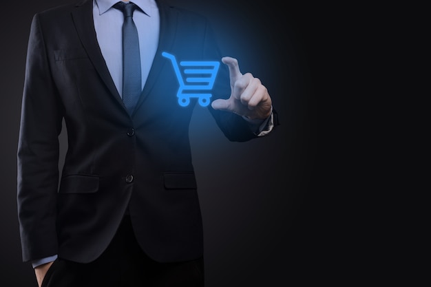 Businessman man holding shopping cart trolley mini cart in business digital payment interface.Business, commerce and shopping concept.