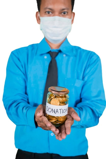 Businessman in mask holding coins for donation