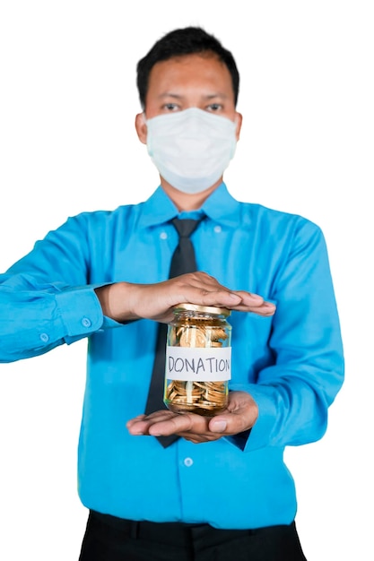 Businessman in mask showing coins for donation