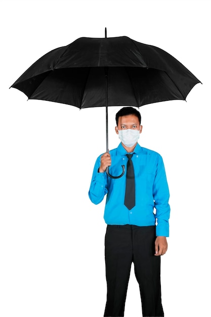 Businessman in medical mask holding umbrella