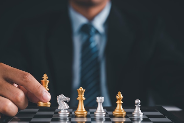 Businessman moves chess with handStrategic planning concept about mistakes topple the opposing team