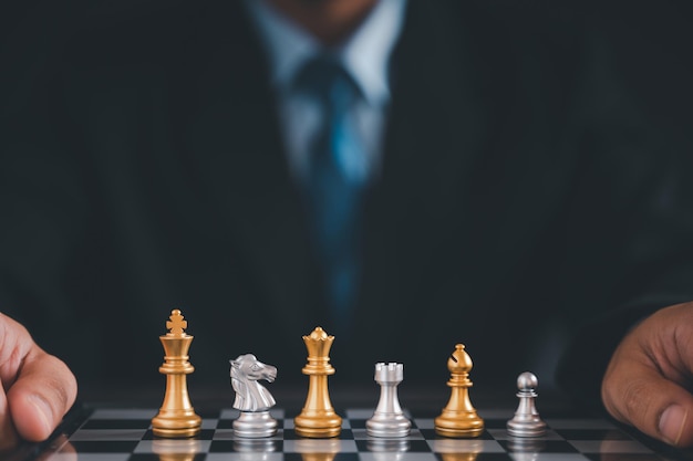 Бизнесмен двигает шахматы рукойконцепция стратегического планирования об ошибках свергает команду противника