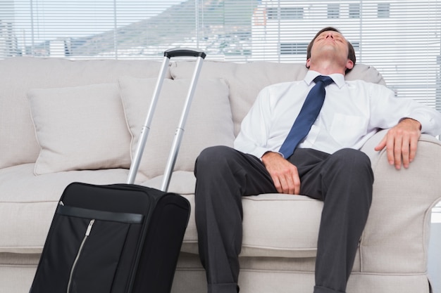 Businessman napping on couch