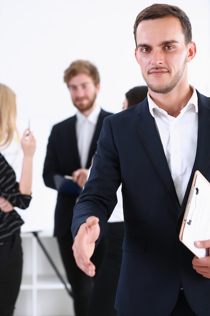 Businessman offer hand to shake as hello closeup