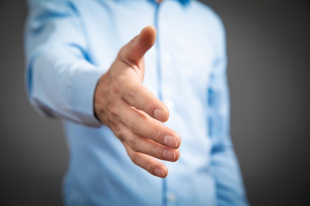 Businessman offering hand for handshake at office