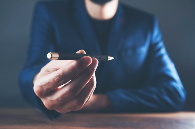 Businessman offering a pen