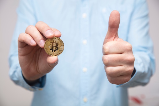 Businessman offers bitcoin in the hand