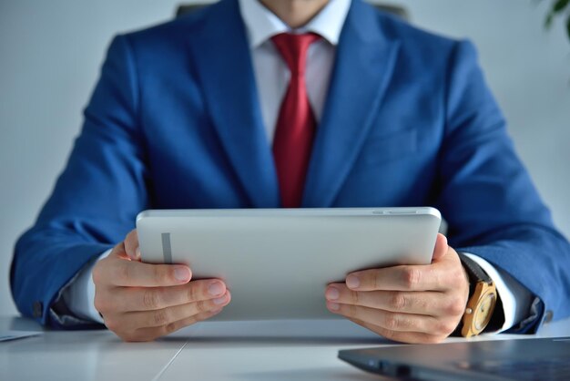 Businessman in office using digital tablet