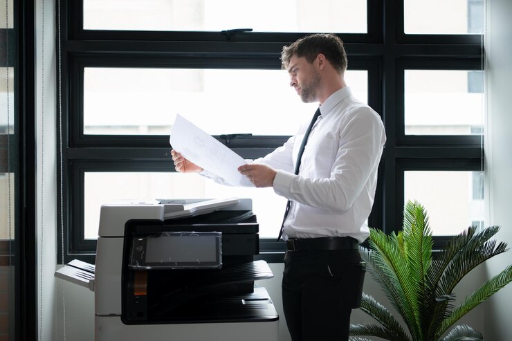 Businessman in office working with copier