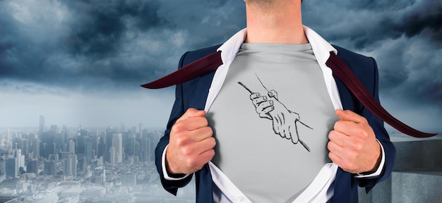 Businessman opening shirt in superhero style against coastline and city