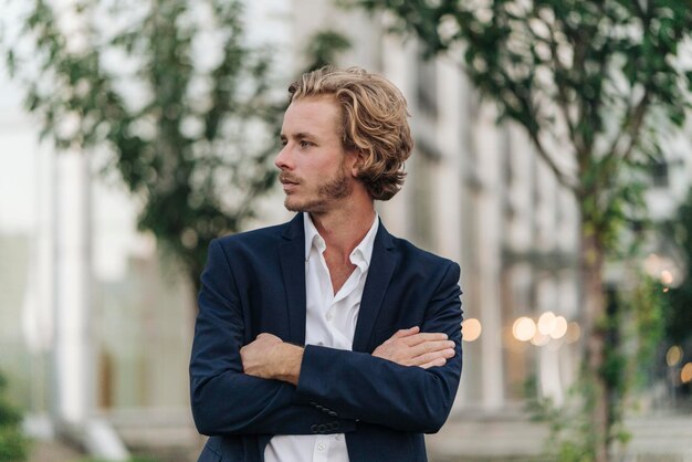 Businessman outdoors looking away