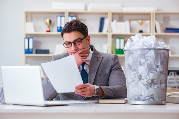 Businessman in paper recycling concept in office