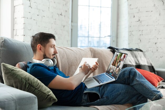 Businessman participate video conference looking at laptop screen during virtual meeting, videocall webcam app for business, close up. Remote working, freelance, education, lifestyle concept.