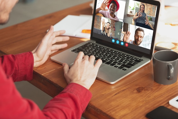 Businessman participate video conference looking at laptop screen during virtual meeting, videocall webcam app for business, close up. Remote working, freelance, education, lifestyle concept.