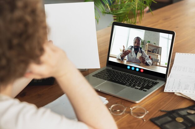 Businessman participate video conference looking at laptop screen during virtual meeting, videocall webcam app for business, close up. Remote working, freelance, education, lifestyle concept.