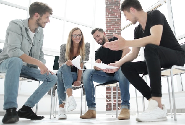 Businessman passing agreement to the business partner in conference room Group of businessmen and businesswomen working together