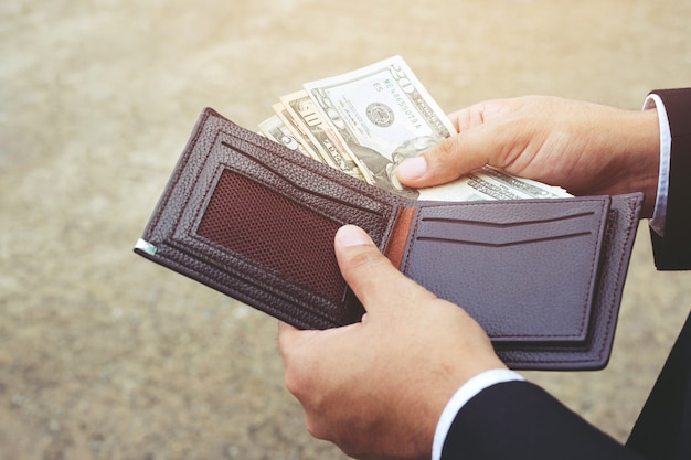 Businessman person holding an wallet in the hands of an man