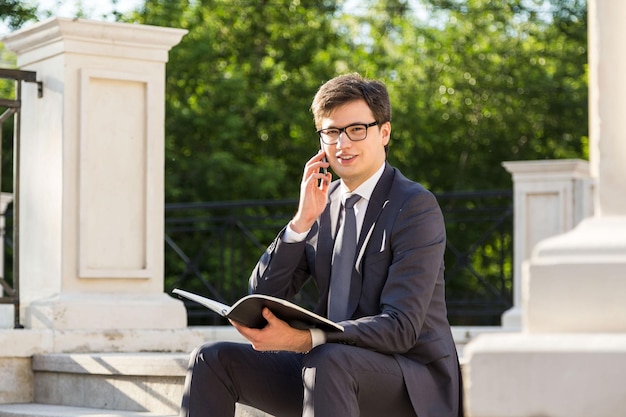 Businessman on phone holding notepad