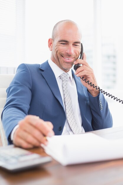 Businessman on the phone and writing notes