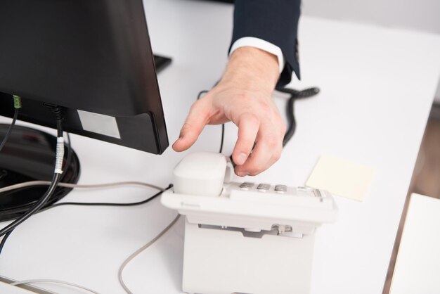 Businessman Pick Up Or Hangs Up The Phone In The Office