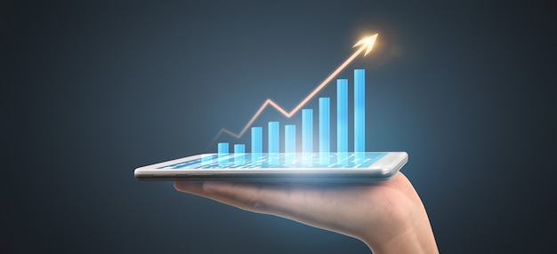 Businessman plan graph growth and increase of chart positive indicators in his business,tablet in hand