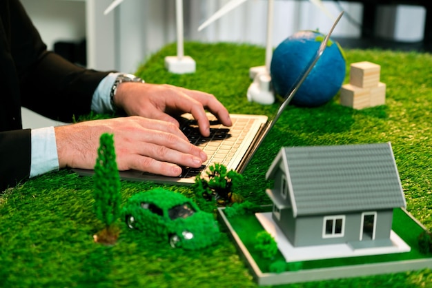Businessman planning on his laptop with ECO strategy. Quaint
