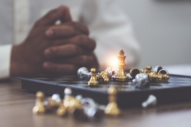 Businessman playing or moving chess figure in competition success play