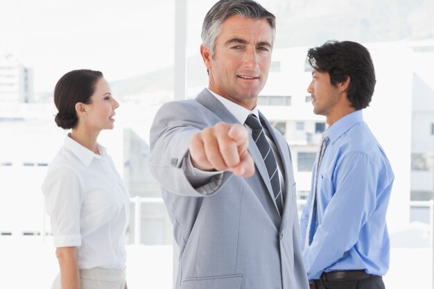 Businessman pointing to the camera