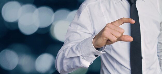 Businessman pointing empty fingers on blurred background